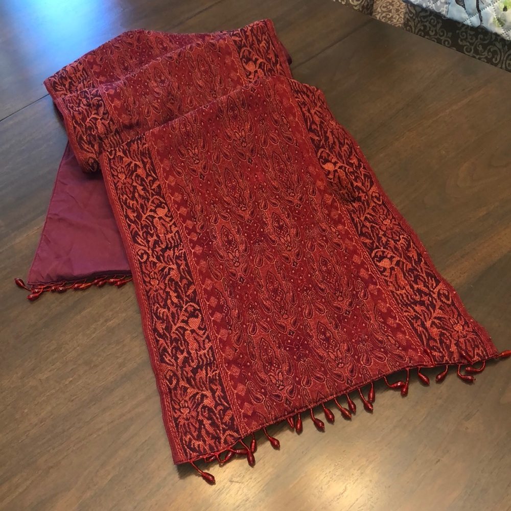 Beautiful red table runner with beaded detail on ends.